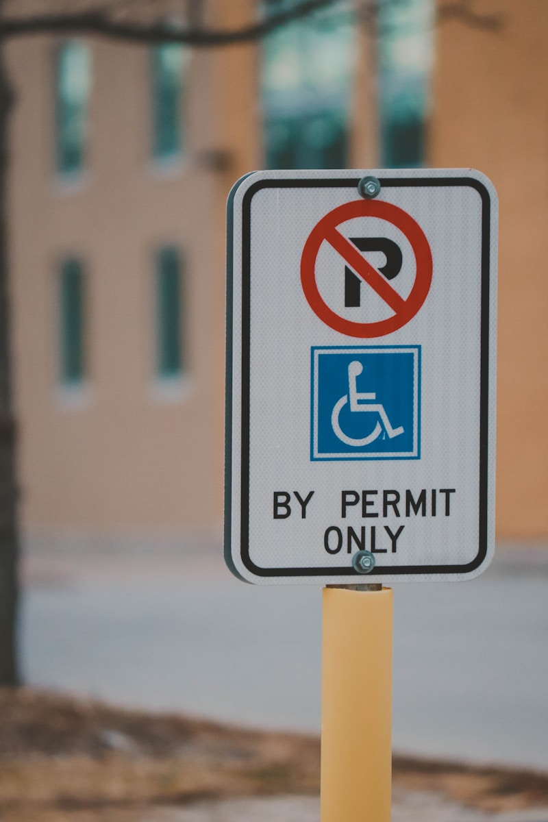 a no parking sign on a pole in front of a building