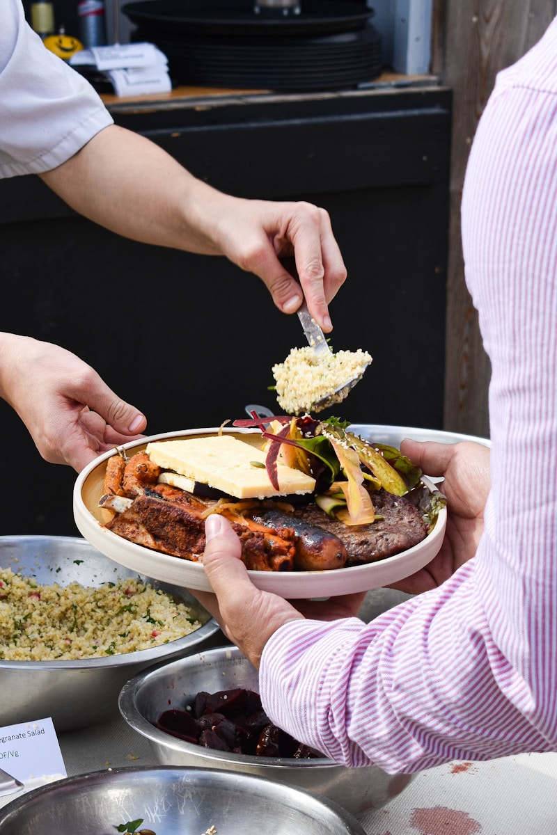 a person holding a plate of food